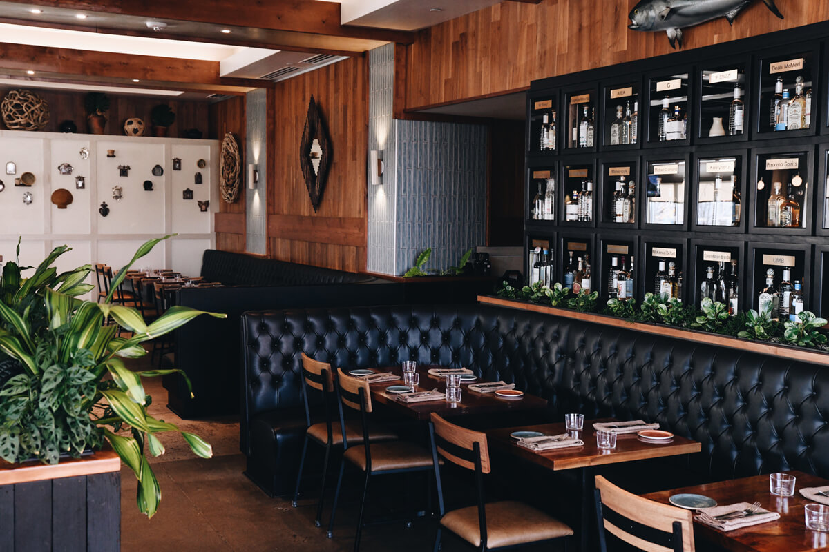 Upscale restaurant interior with leather booths and tequila wall